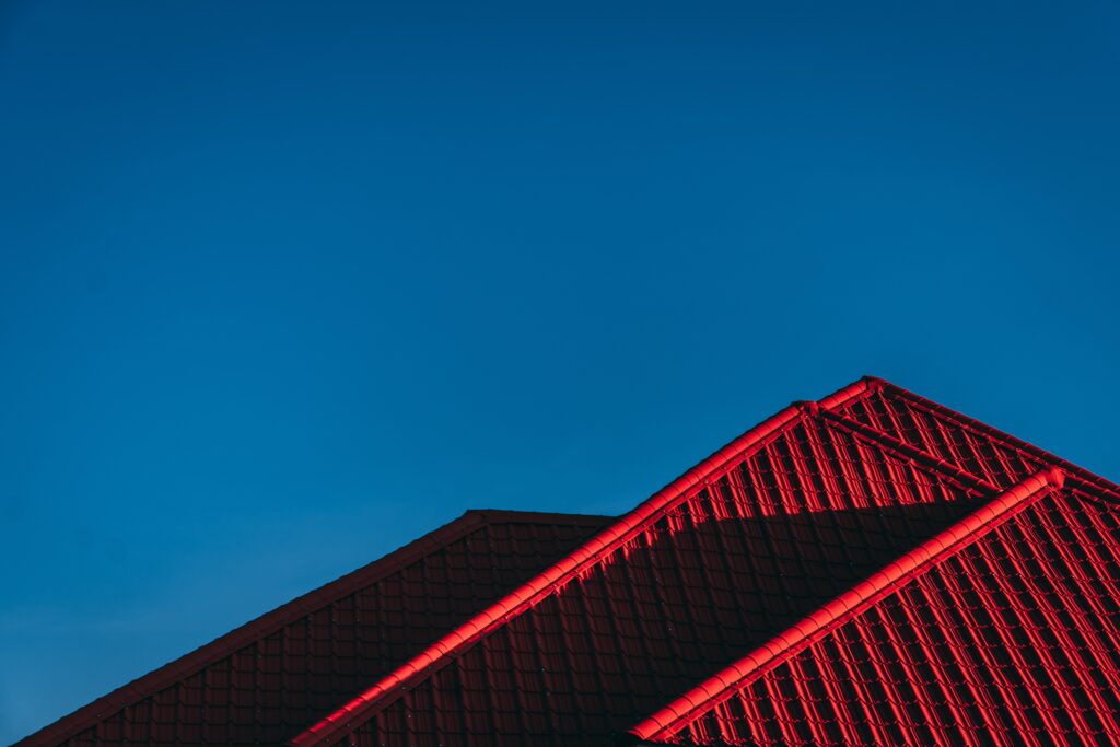 this red colourbond roof shown against the blue sky would have a manhole to the roof void