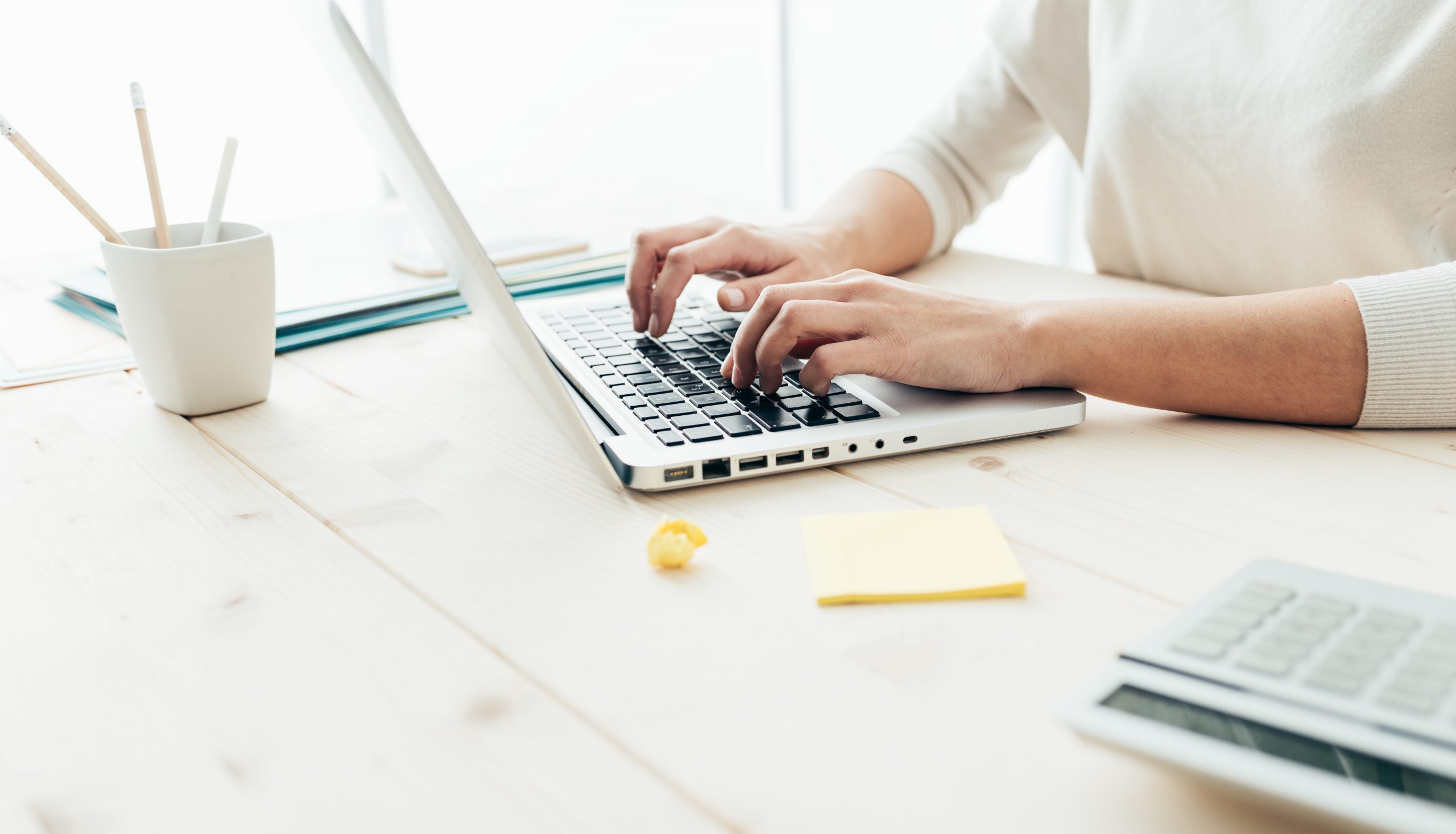 Woman at laptop typing