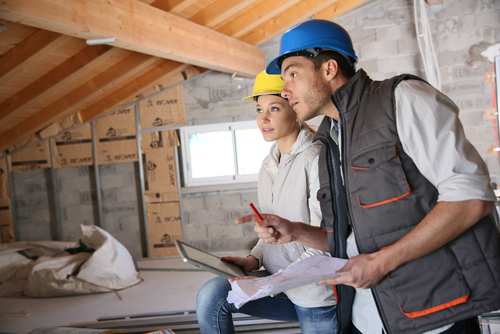 two building inspection professionals inspecting roof