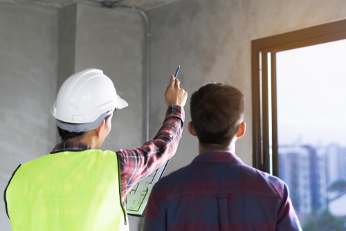 building inspection with client inside concrete building
