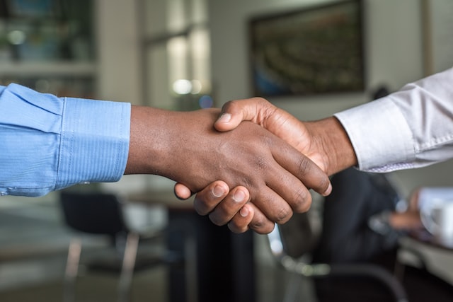 insurance broker shakes hands before explaining how much pest control insurance can cost