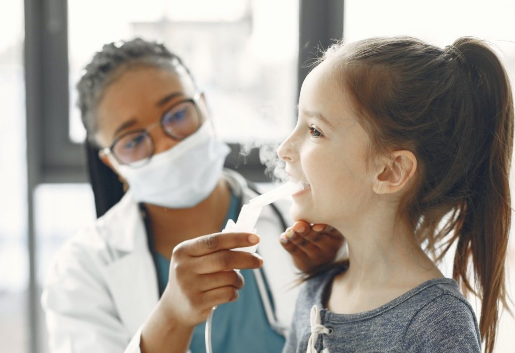 young girl being treated for asthma caused by cockroach droppings and shedding